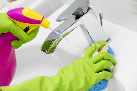 A person is cleaning a sink
