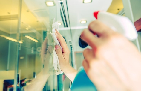 A person is cleaning the glass