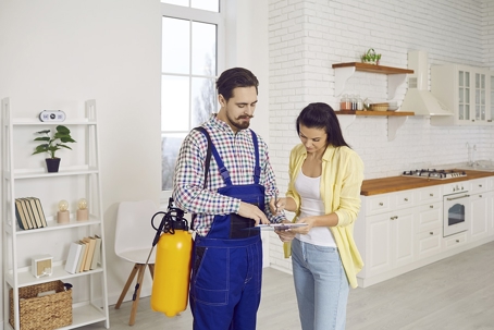 A pest control service personnel and the homeowner