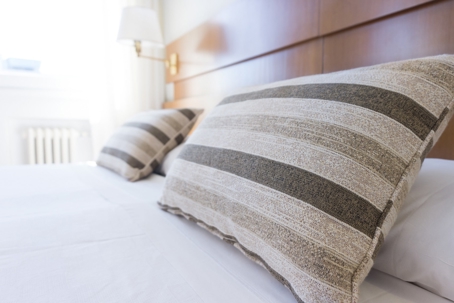Striped pillows on a big clean bed