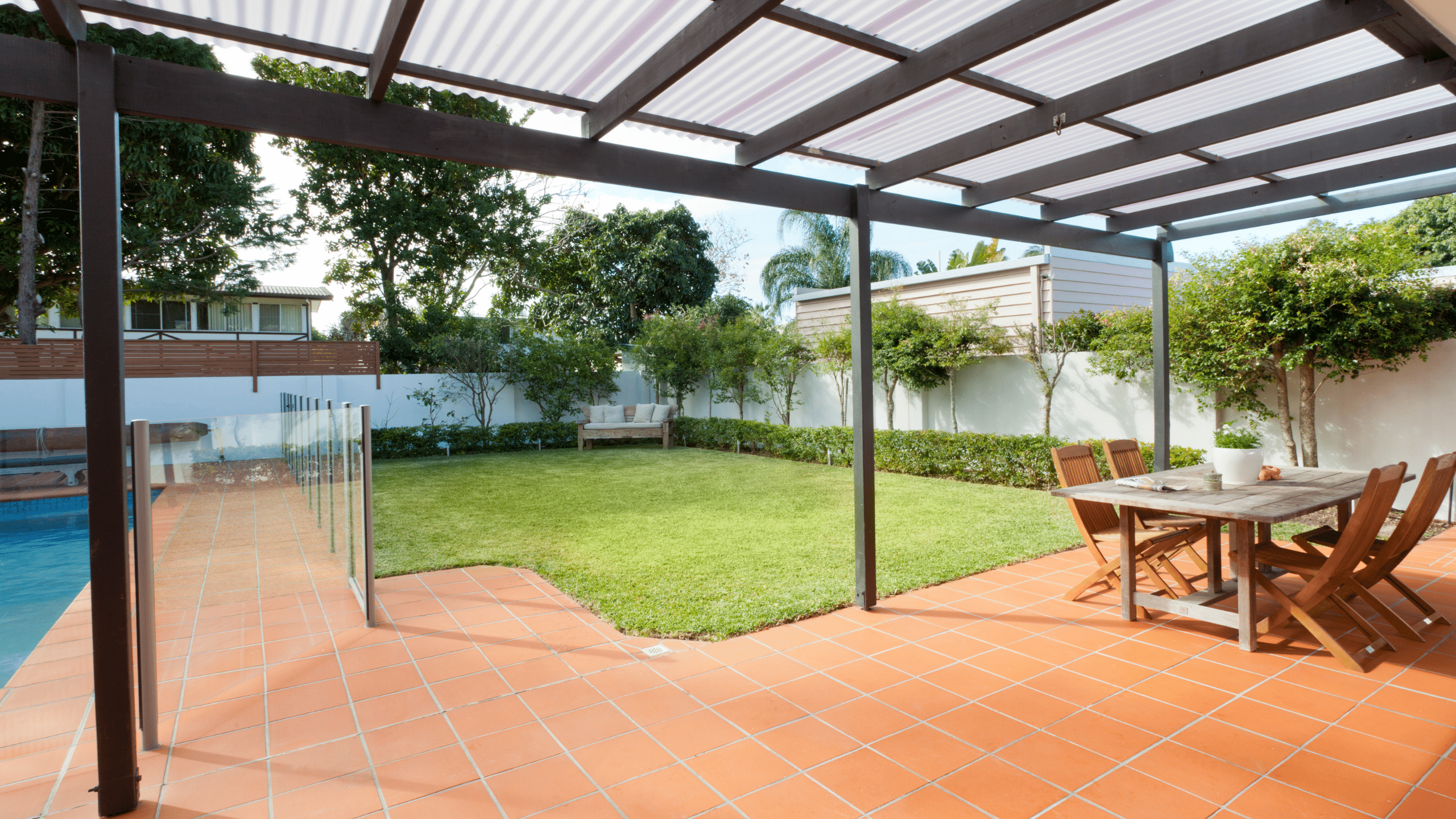 patio and backyard with grass and palm trees